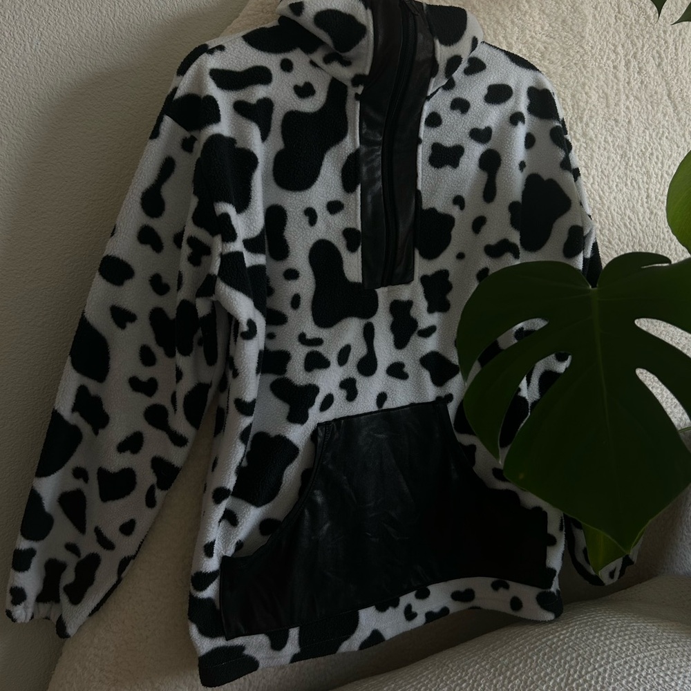 Cow print fleece! With large vegan leather stretchy kangaroo pocket.